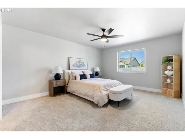 a spacious bedroom with a bed and a window