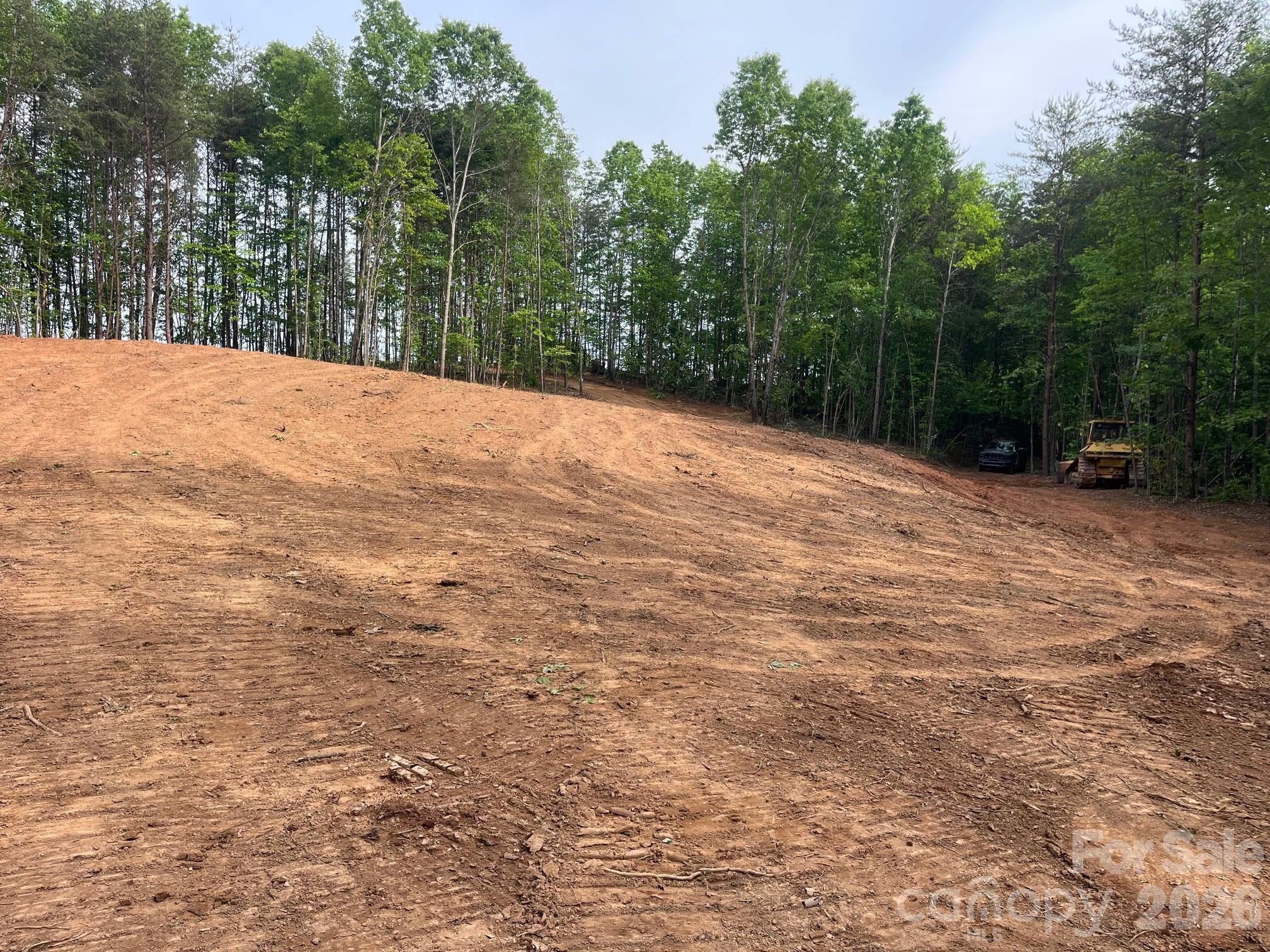 Tbd Vein Mountain Road, Unit 5 Nebo, NC 28761 - Photo 5 of 14 a backyard of a house with trees and houses