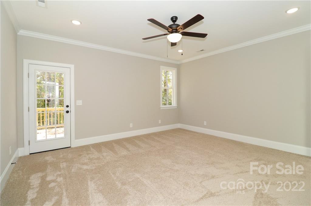 289 Ikerd Drive Southeast Concord, NC 28025 - Photo 11 of 24 an empty room with windows and ceiling fan
