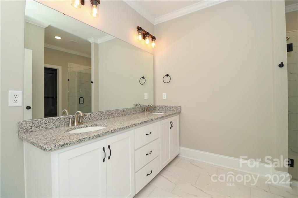 289 Ikerd Drive Southeast Concord, NC 28025 - Photo 13 of 24 a bathroom with a granite countertop sink and a mirror