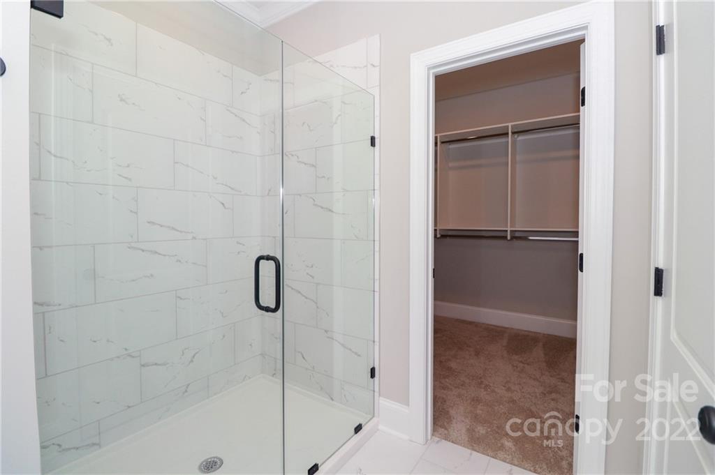 289 Ikerd Drive Southeast Concord, NC 28025 - Photo 14 of 24 a bathroom with a glass shower door