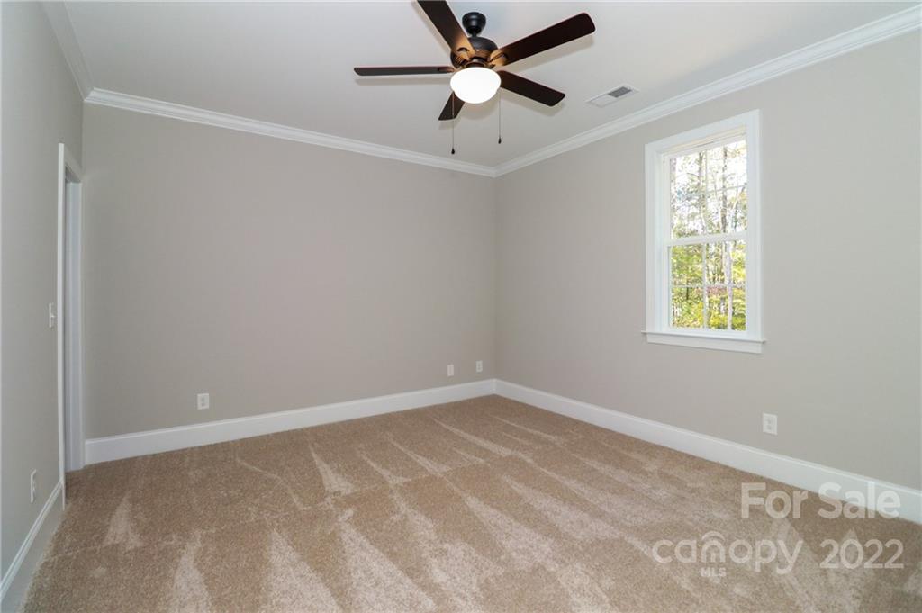 289 Ikerd Drive Southeast Concord, NC 28025 - Photo 19 of 24 an empty room with a window and a fan