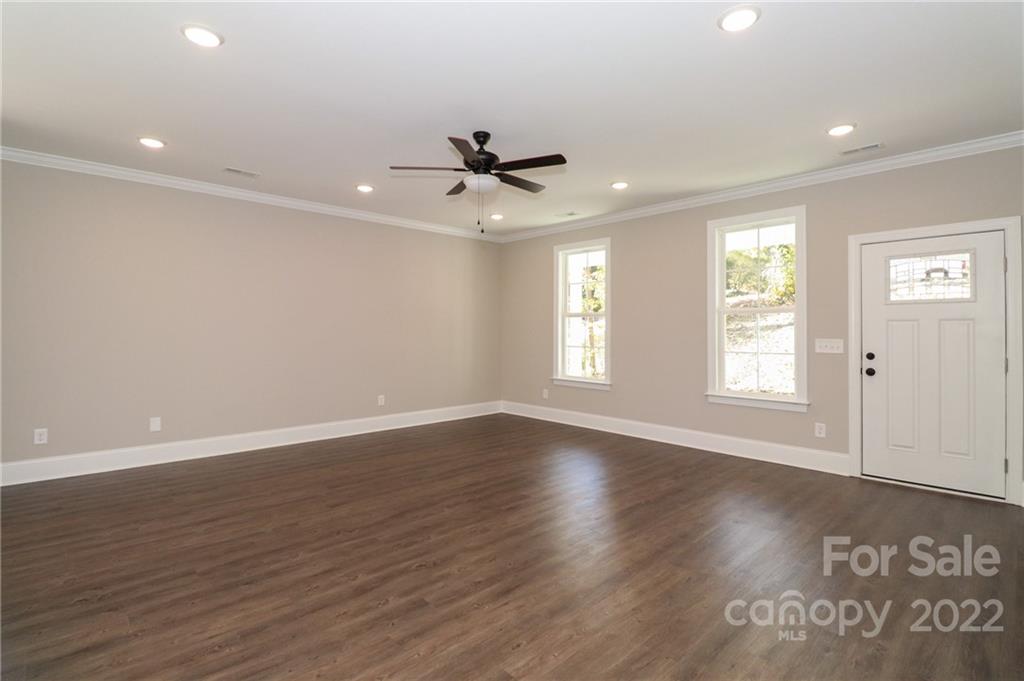 289 Ikerd Drive Southeast Concord, NC 28025 - Photo 3 of 24 a view of an empty room with a window and wooden floor