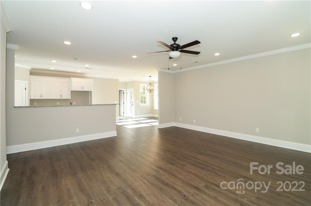 289 Ikerd Drive Southeast Concord, NC 28025 - Photo 6 of 24 a view of a kitchen with an empty space and a ceiling fan