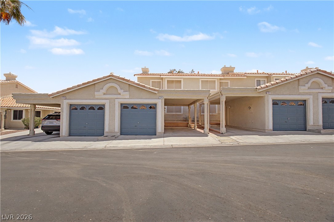 2243 Rugged Mesa Drive Laughlin, NV 89029 - Photo 26 of 32 A Mediterranean-inspired townhouse facade with attached garages and carports.
