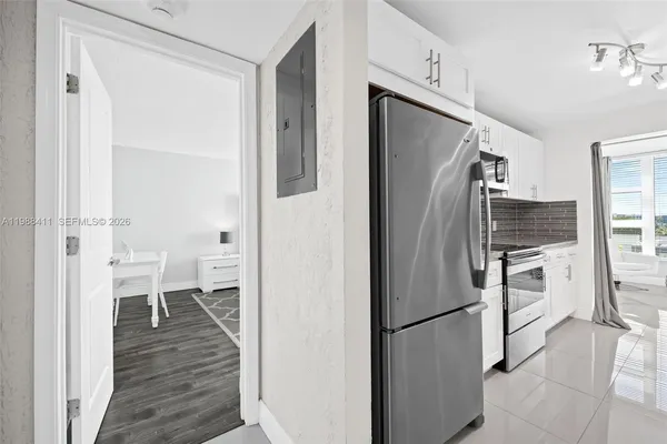 a kitchen with stainless steel appliances a refrigerator and a stove top oven