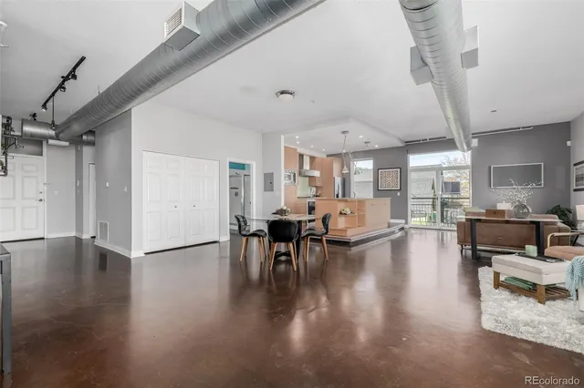 a lobby with furniture and a wooden floor