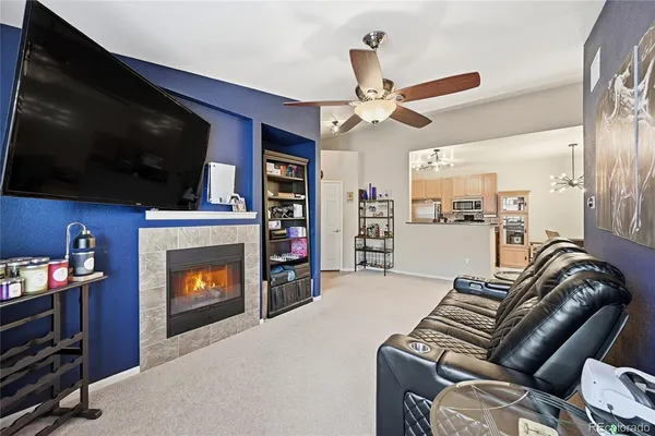 a living room with furniture a flat screen tv and a fireplace