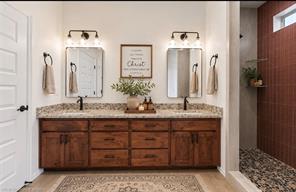 6138 New Hope Road Hackett, AR 72937 - Photo 11 of 56 Dual vanity with wood-finish cabinetry and stone countertop