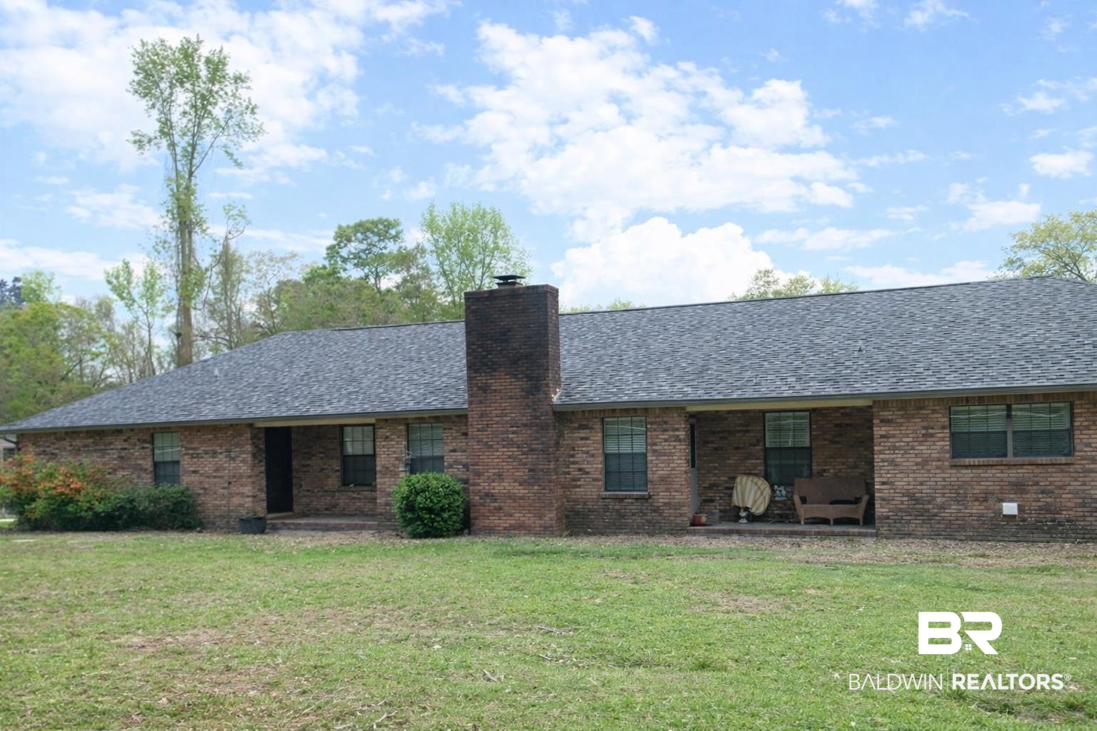 2538 Old Castleberry Road Brewton, AL 36426 - Photo 11 of 12 Back of property featuring brick siding, a lawn, a chimney, and a shingled roof