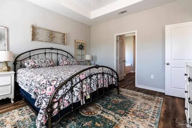 a bedroom with a bed table and a window
