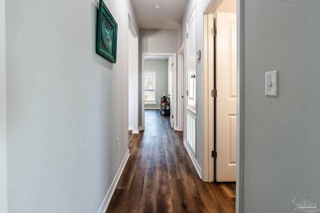 a view of a livingroom with wooden floor and stairs