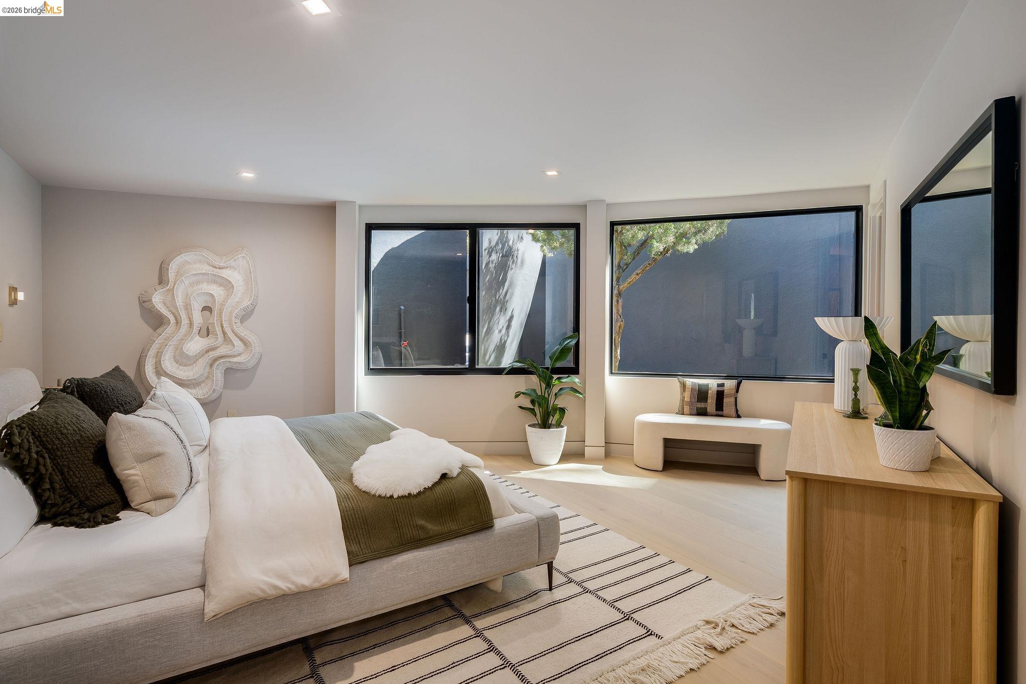 5645 Bacon Road Oakland, CA 94619 - Photo 55 of 94 Spacious room featuring light wood-finish flooring, recessed lighting, and expansive black-framed windows