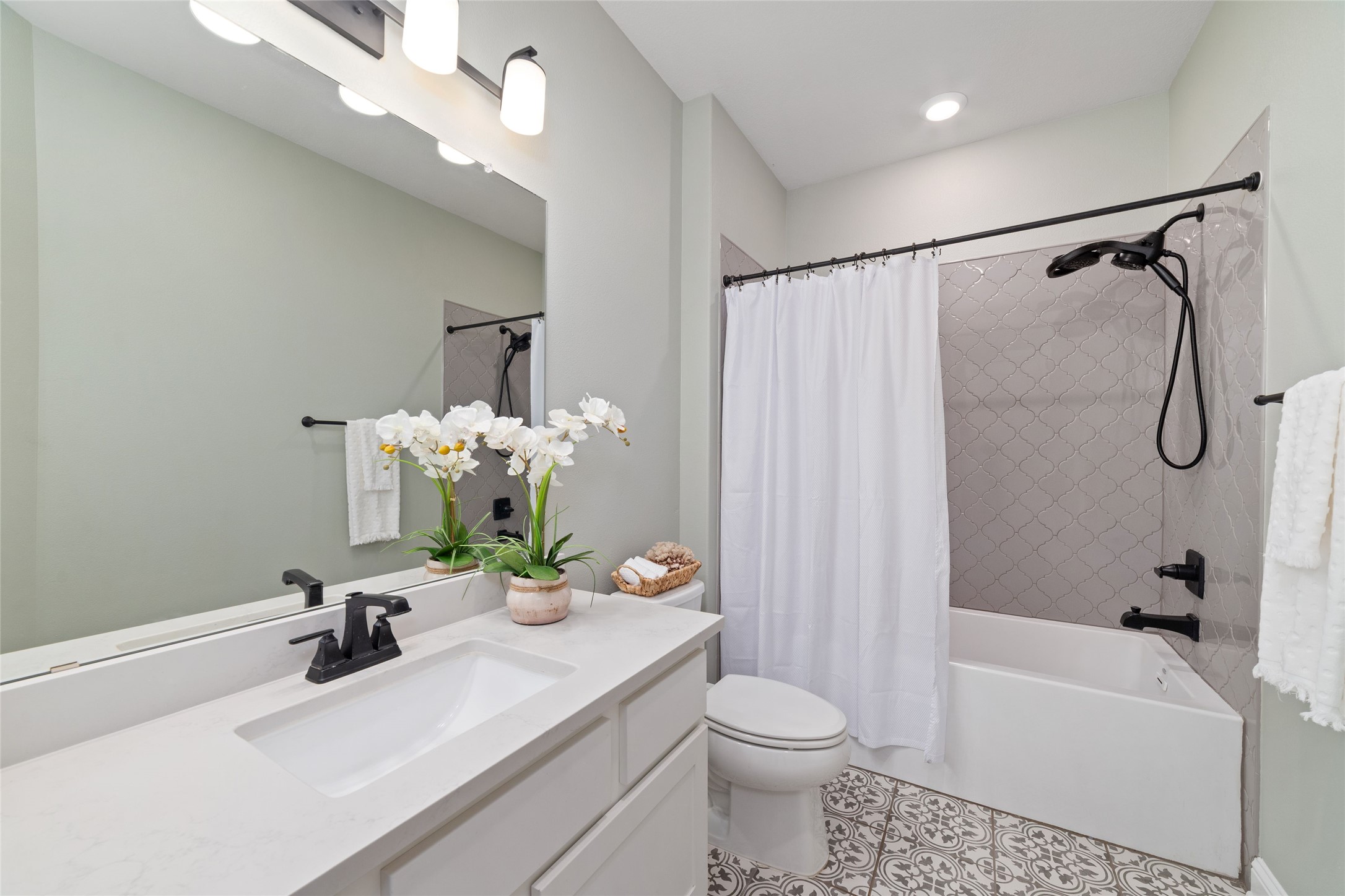 1011 Bonfire West Road Cat Spring, TX 78933 - Photo 27 of 48 Secondary bathroom has beautiful tile in the bath area as well as gorgeous flooring that adds character to this space.