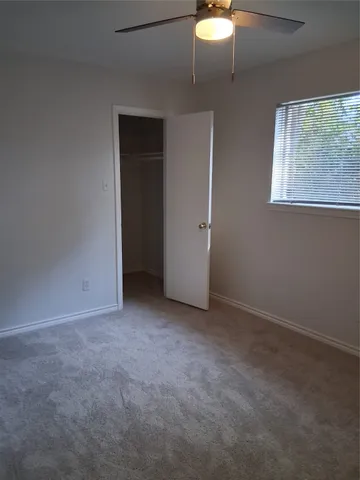 an empty room with a empty space and a ceiling fan