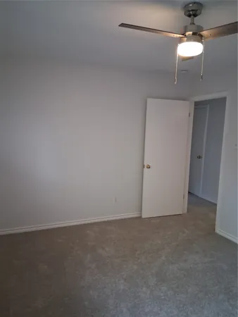 an empty room with a empty space and a ceiling fan