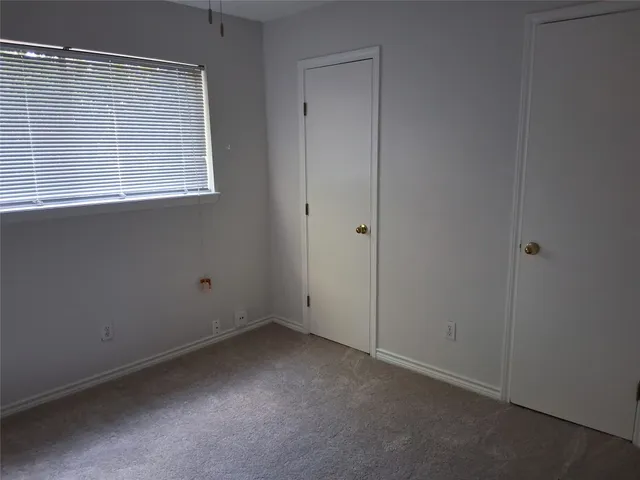 a view of a livingroom with a ceiling fan and window