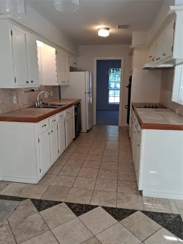 a kitchen with a sink window and cabinets