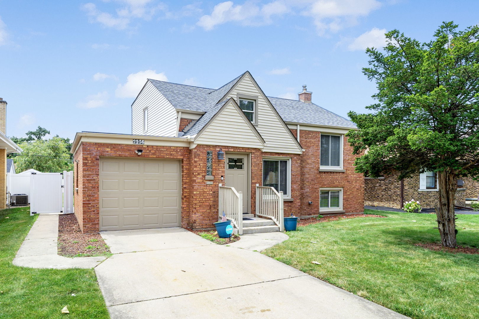 2256 18th Avenue North Riverside, IL 60546 - Photo 1 of 33 a front view of a house with a yard and garage