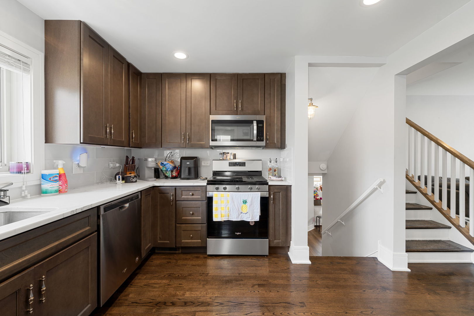 2256 18th Avenue North Riverside, IL 60546 - Photo 6 of 33 a kitchen with stainless steel appliances granite countertop a stove top oven a sink dishwasher and a microwave oven with wooden floor