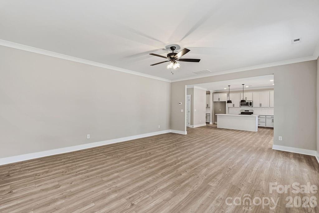 1024 Baylor Grove Road, Unit 19 Monroe, NC 28112 - Photo 21 of 47 a view of a big room with wooden floor and windows