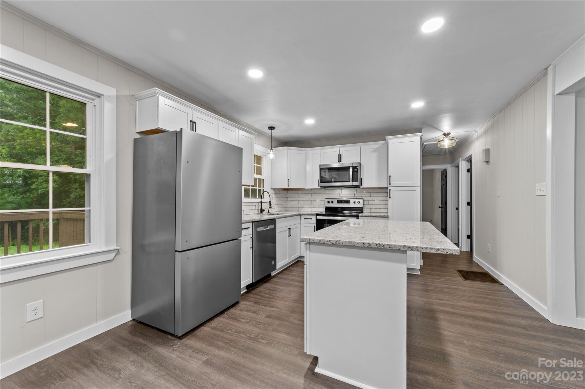 1809 Feature Road Lancaster, SC 29720 - Photo 12 of 32 a kitchen with stainless steel appliances a refrigerator and a stove top oven