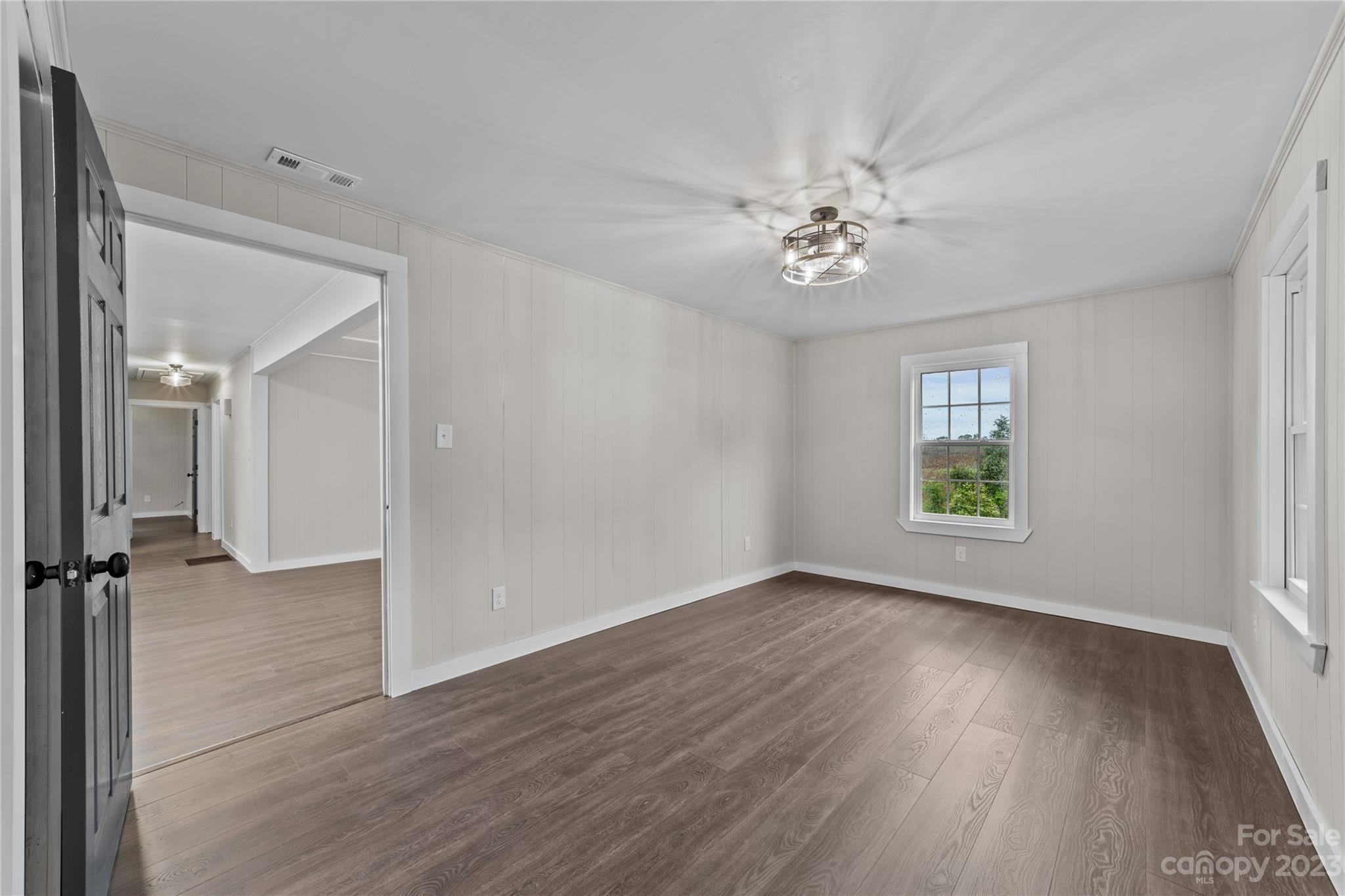 1809 Feature Road Lancaster, SC 29720 - Photo 17 of 32 a view of an empty room with a window and wooden floor
