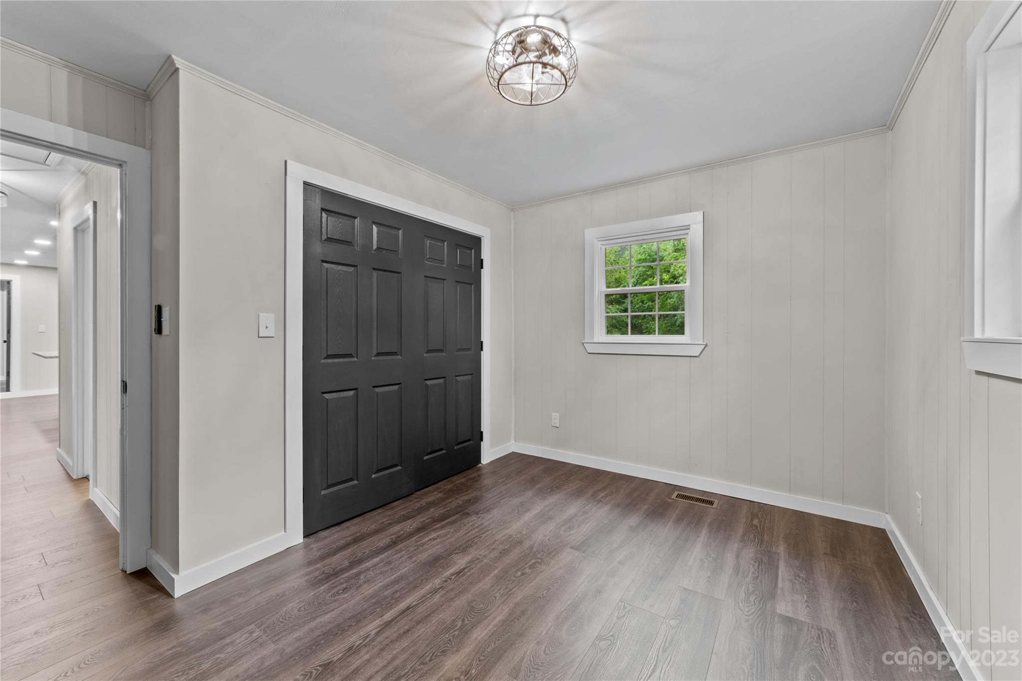 1809 Feature Road Lancaster, SC 29720 - Photo 25 of 32 an empty room with wooden floor cabinet and windows