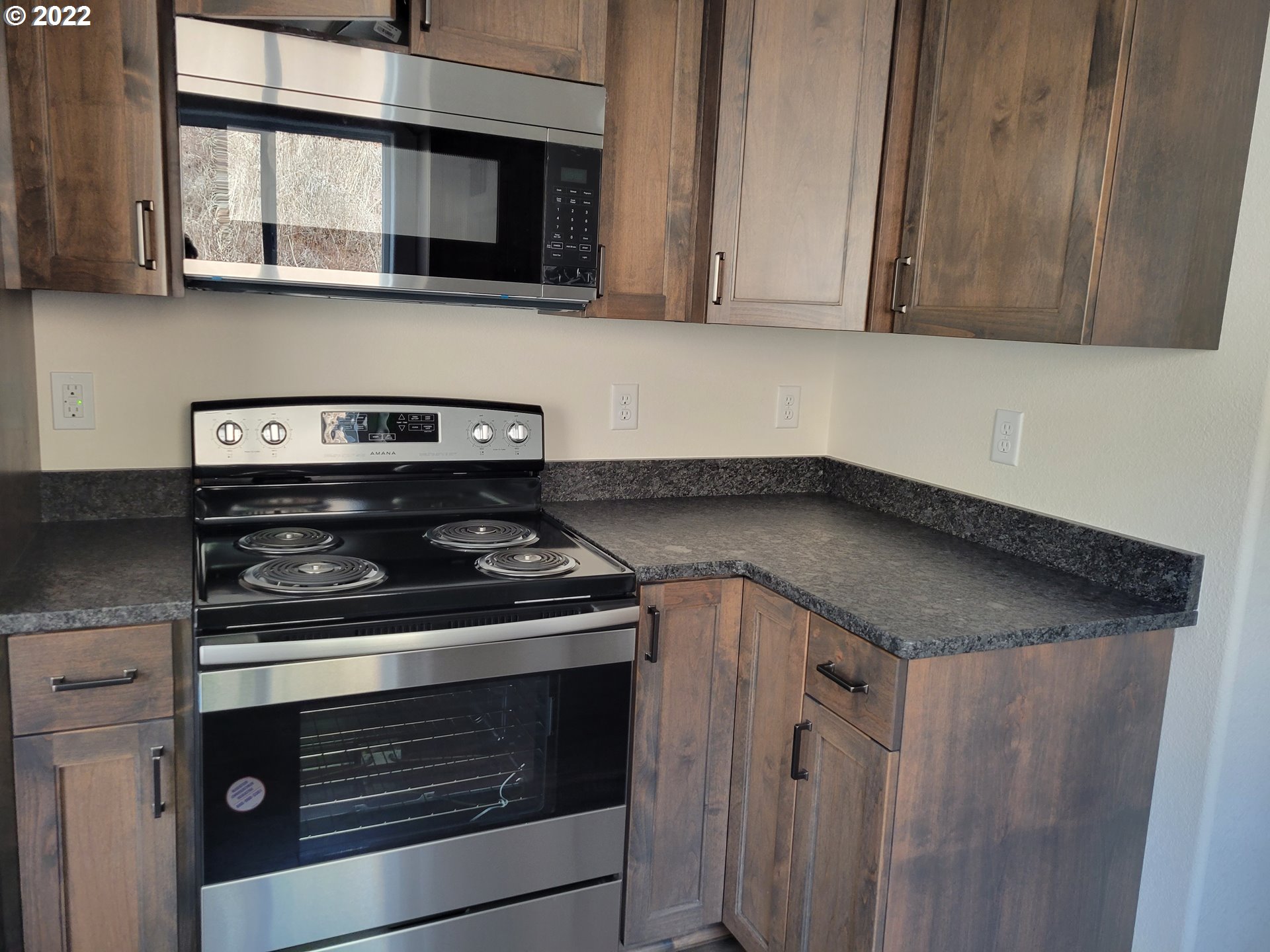 195 Armande Loop Roseburg, OR 97471 - Photo 14 of 28 a kitchen with granite countertop a stove and a microwave