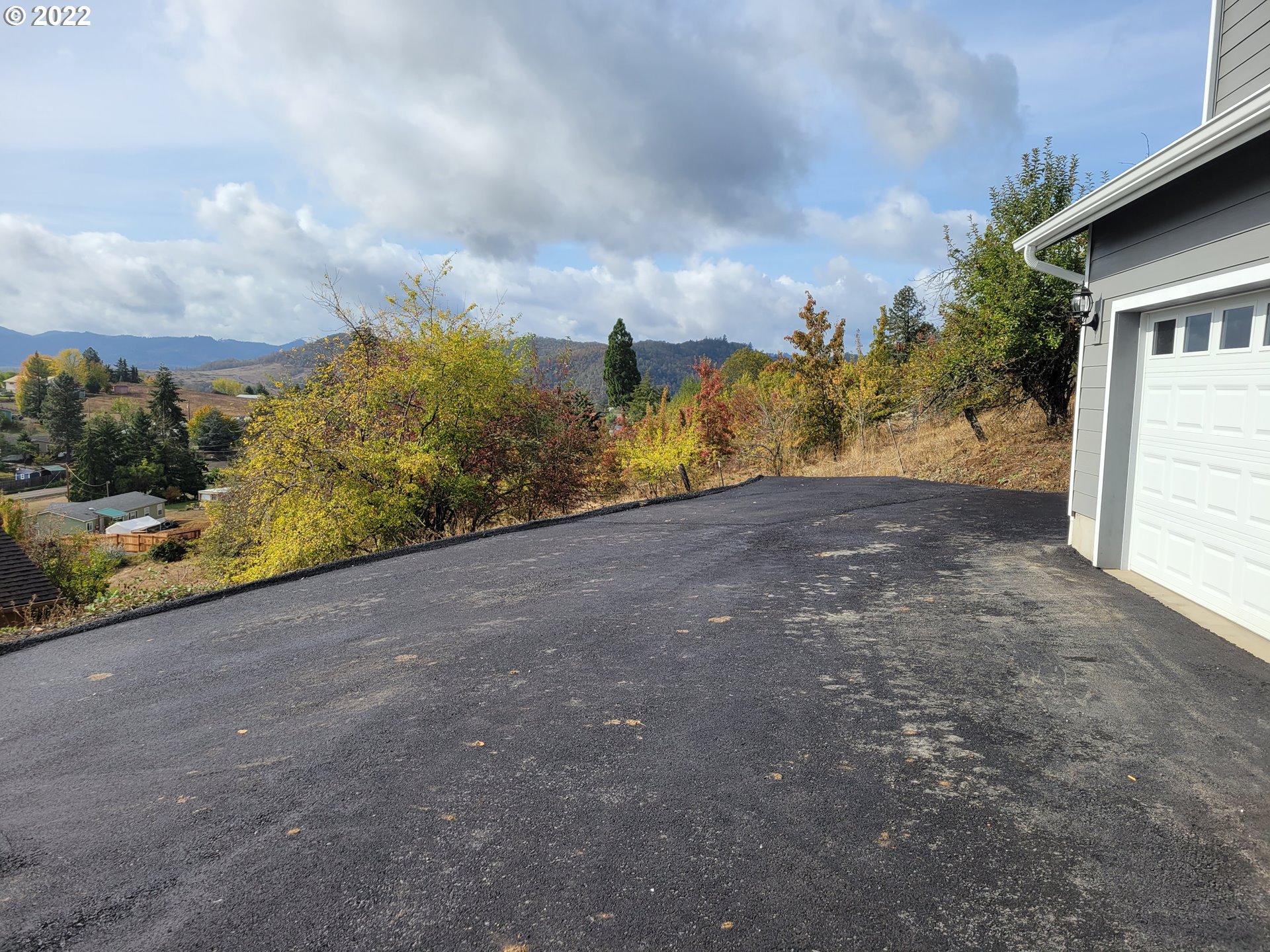 195 Armande Loop Roseburg, OR 97471 - Photo 28 of 28 a view of dirt field with trees in the background