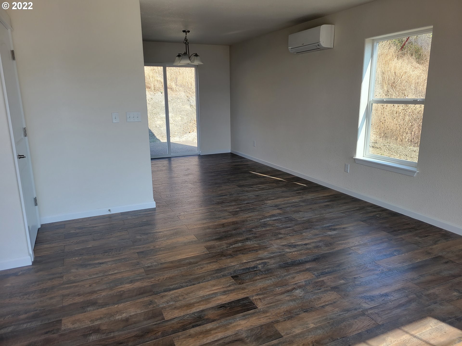 195 Armande Loop Roseburg, OR 97471 - Photo 4 of 28 an empty room with wooden floor and windows