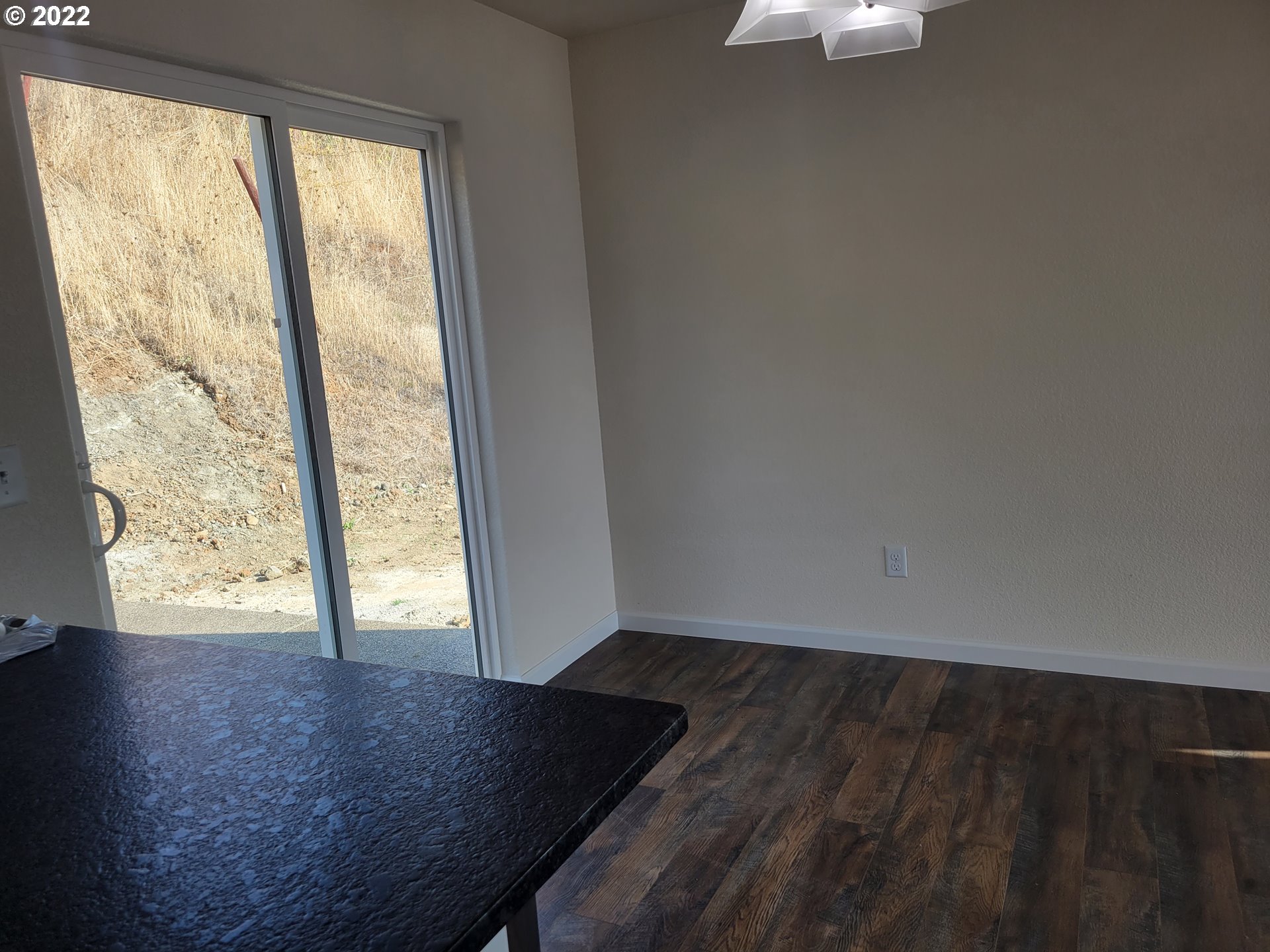 195 Armande Loop Roseburg, OR 97471 - Photo 5 of 28 an empty room with wooden floor and windows