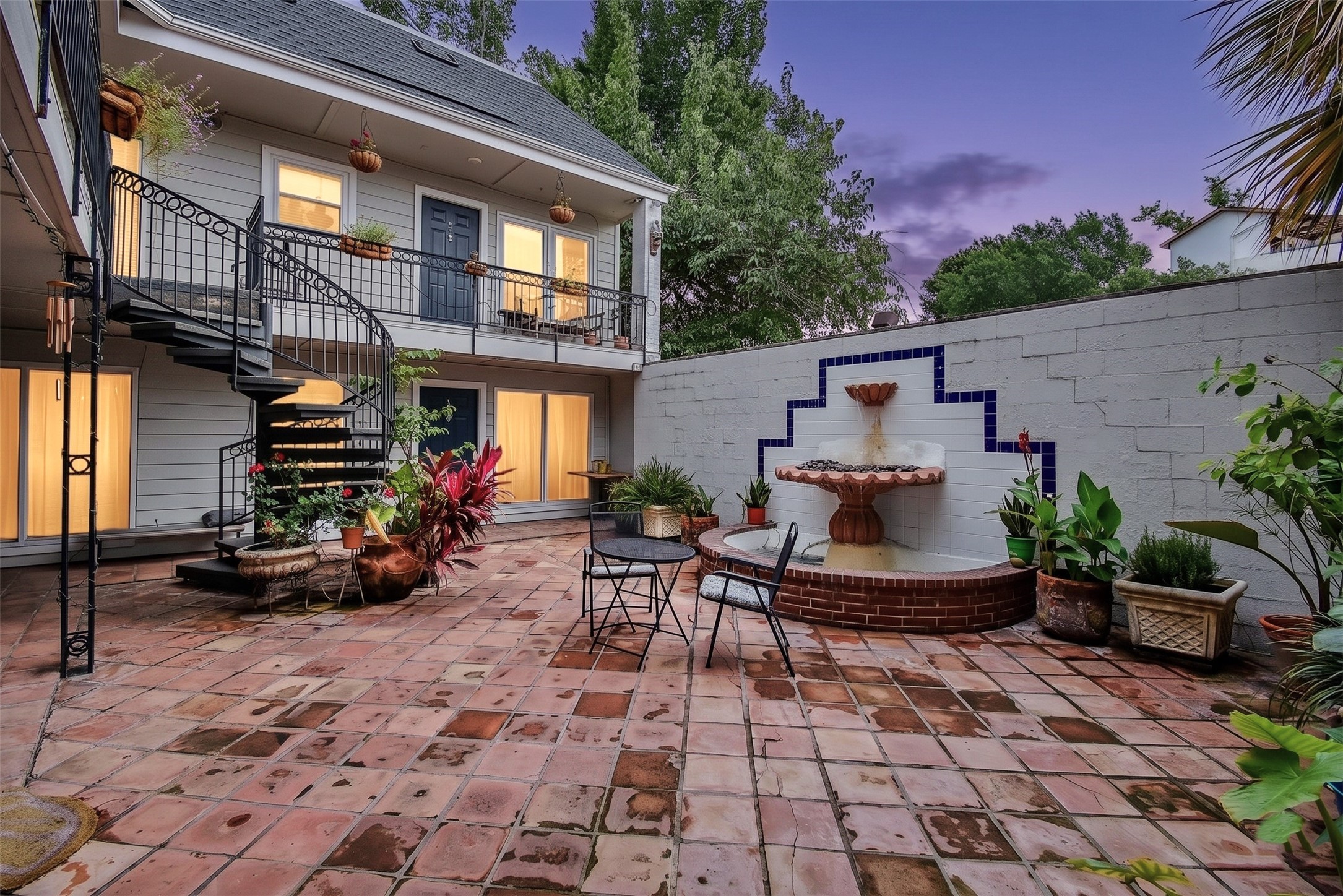 1404 Welch Street, Unit 2 Houston, TX 77006 - Photo 1 of 20 Beautifully landscaped courtyard with fountain feature and multiple seating areas, offering a peaceful retreat in the heart of the community. 1404 Welch St. Unit #2 is located on the first floor.