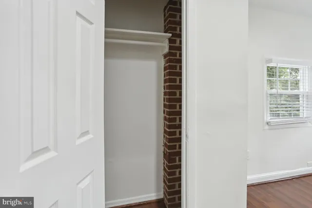a close view of closet with wooden floor