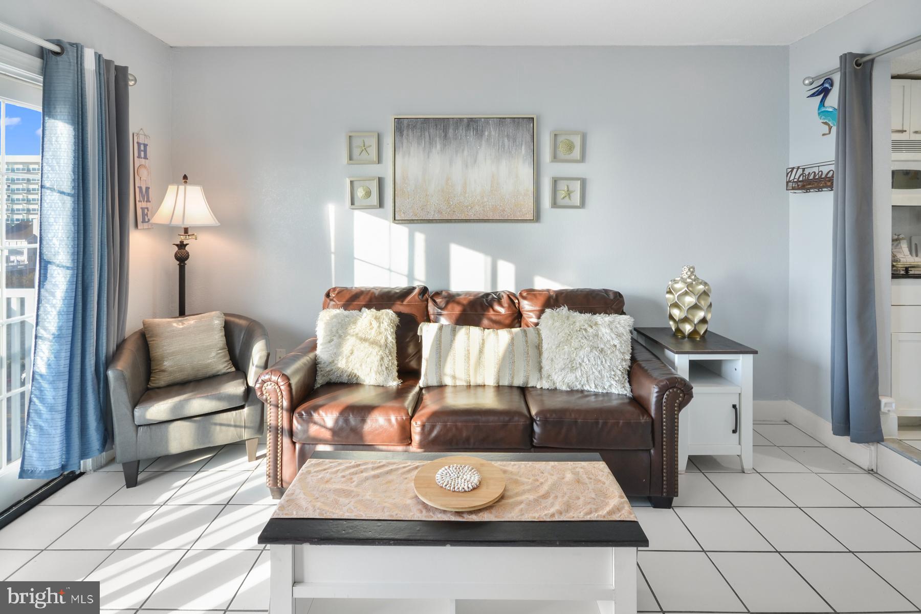 200 59th Street, Unit 302 Ocean City, MD 21842 - Photo 2 of 33 a living room with furniture and wooden floor
