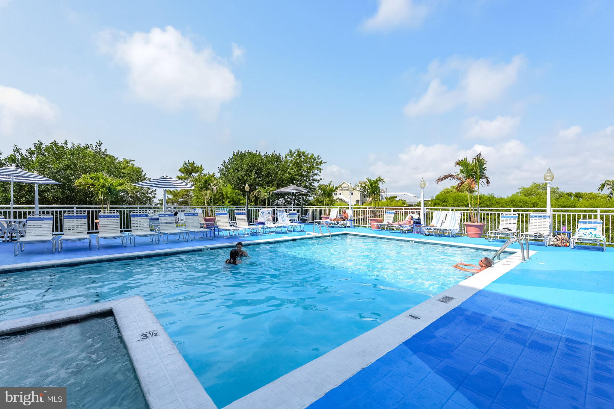 200 59th Street, Unit 302 Ocean City, MD 21842 - Photo 21 of 33 a view of a swimming pool with a lounge chairs