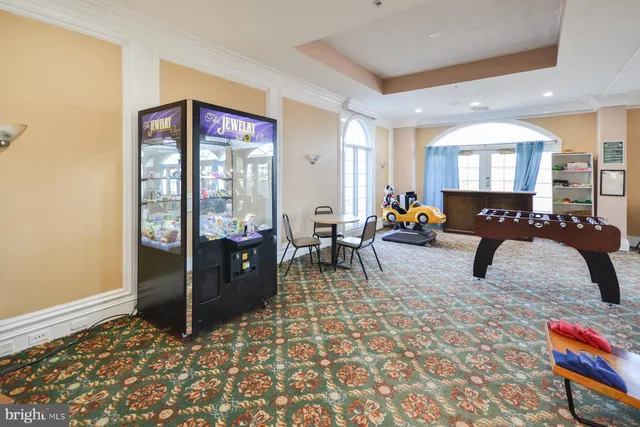a view of a workspace with furniture and a flat screen tv