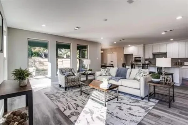 a living room with furniture and a large window