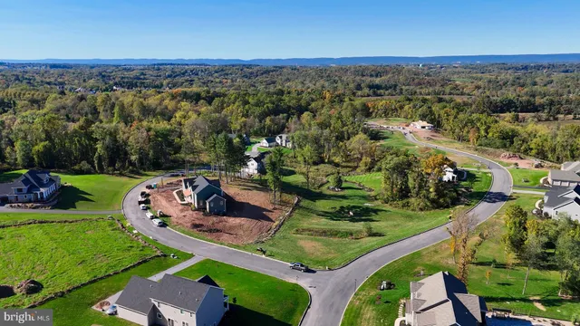 an aerial view of a house with a yard and lake view