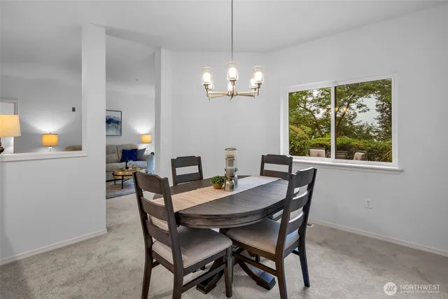 a kitchen with kitchen island granite countertop a sink a counter top space appliances and cabinets