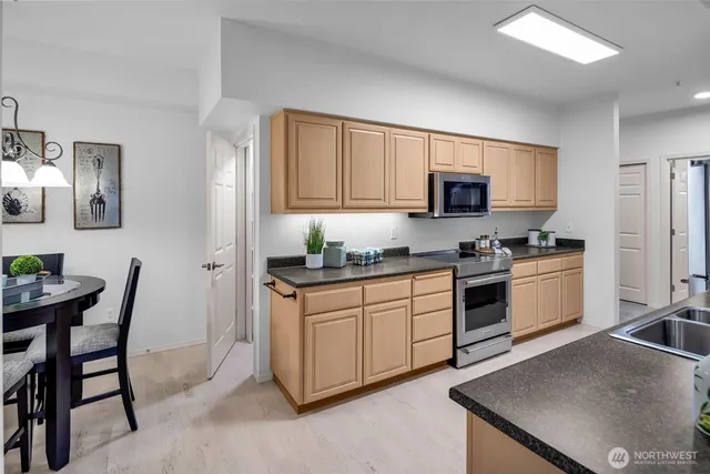 a large kitchen with kitchen island a sink table and chairs