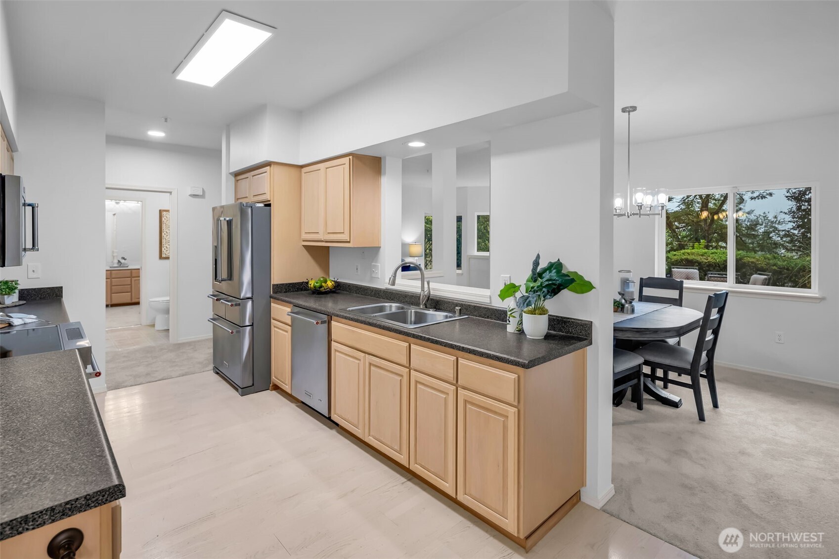 4212 221st Place Southeast, Unit 1561 Issaquah, WA 98029 - Photo 14 of 35 a large kitchen with kitchen island a sink table and chairs