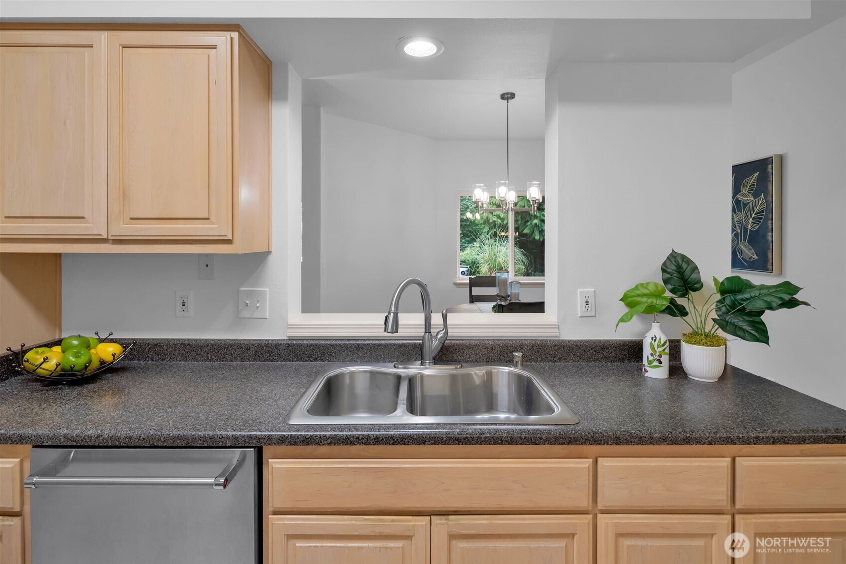 4212 221st Place Southeast, Unit 1561 Issaquah, WA 98029 - Photo 15 of 35 a kitchen with a sink a potted plant and cabinets