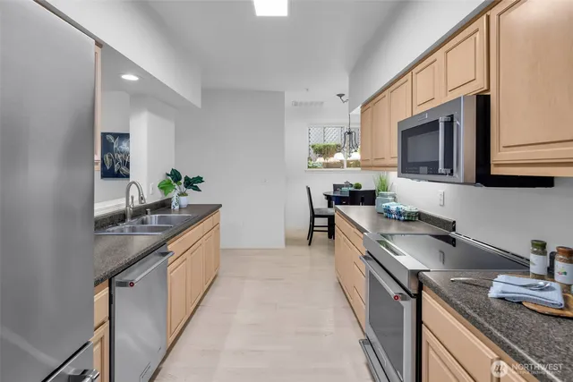 a view of a dining room with furniture a chandelier and wooden floor