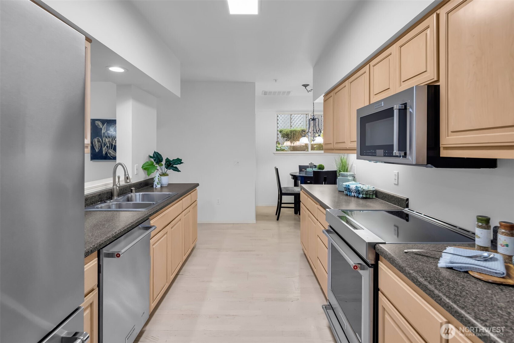 4212 221st Place Southeast, Unit 1561 Issaquah, WA 98029 - Photo 16 of 35 a kitchen with granite countertop a sink stove and cabinets