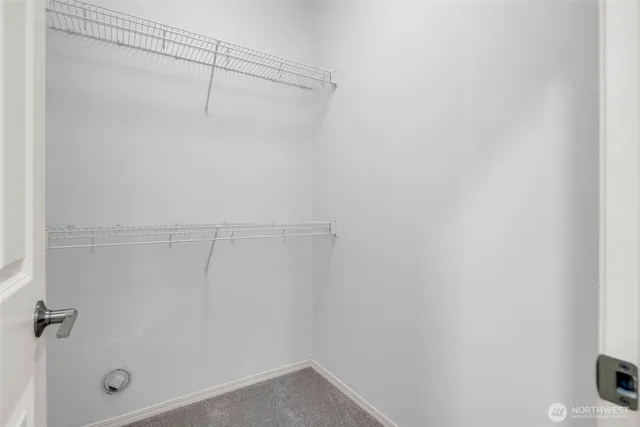 a bedroom with a bed and painting on the wall