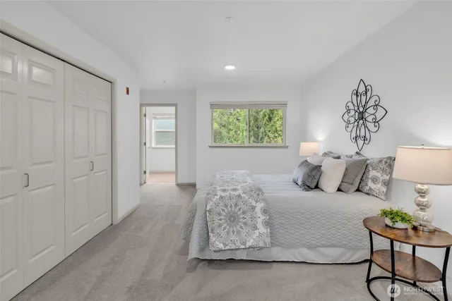 a spacious bedroom with a bed and a window