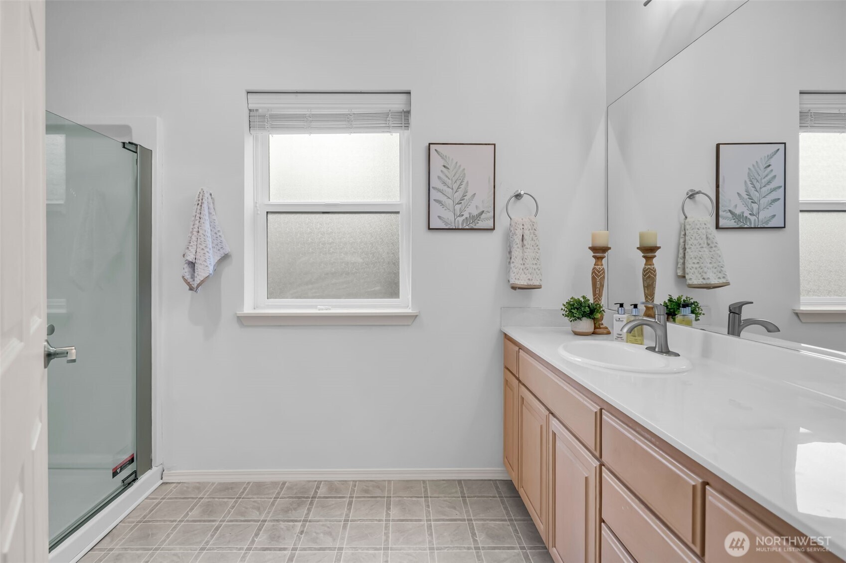 4212 221st Place Southeast, Unit 1561 Issaquah, WA 98029 - Photo 31 of 35 a bathroom with a sink a mirror and a shower