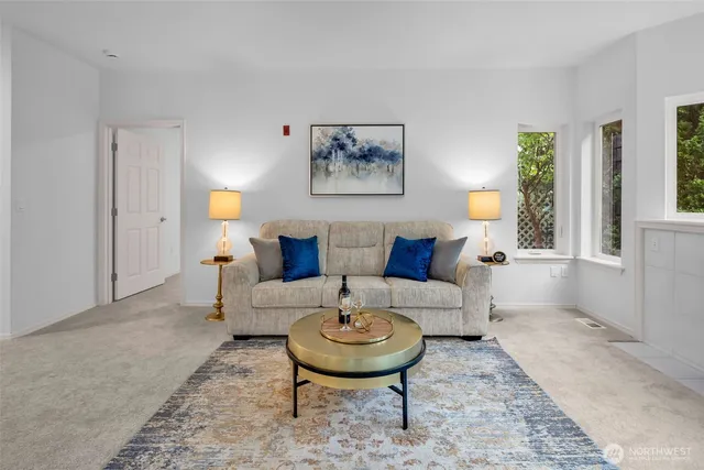 a living room with furniture a fireplace and a table