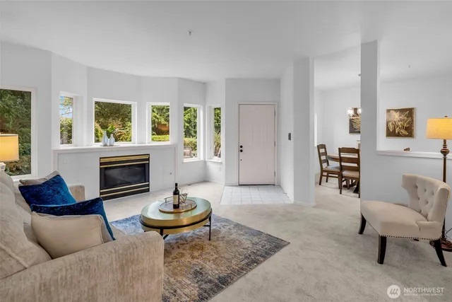 a living room with furniture a rug and a lamp